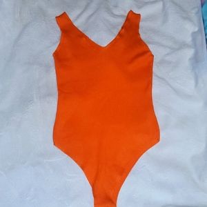 Bright orange one piece body suite